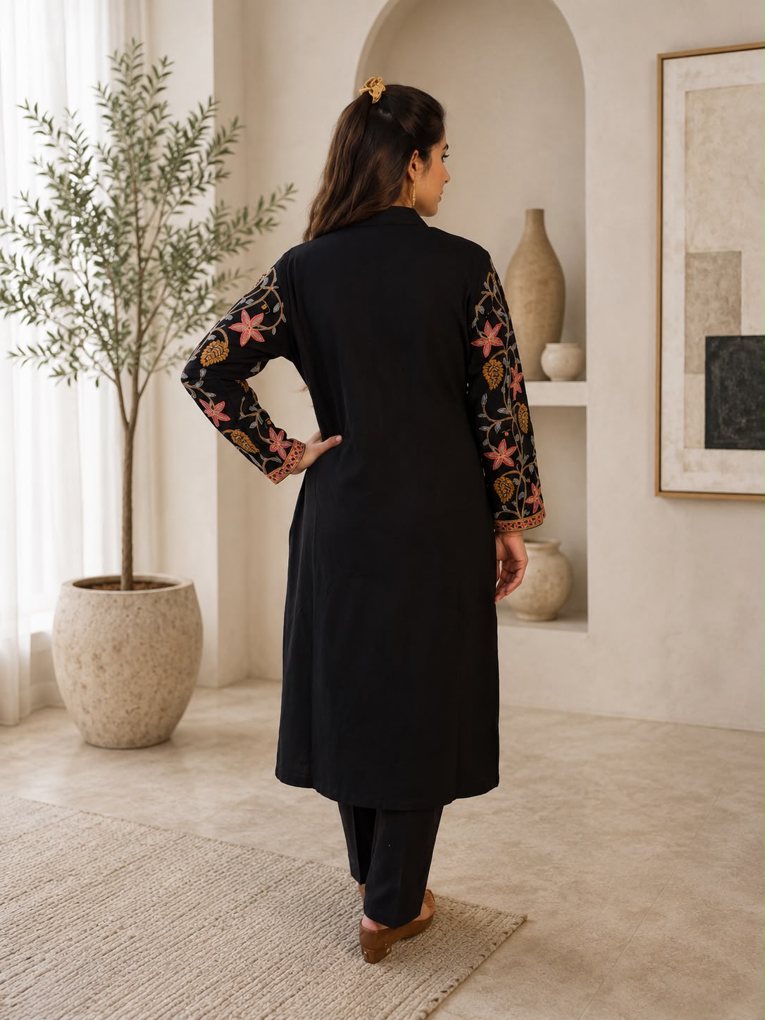 Back view of black Kashmiri kurta set with printed sleeves and matching pants from Adishee