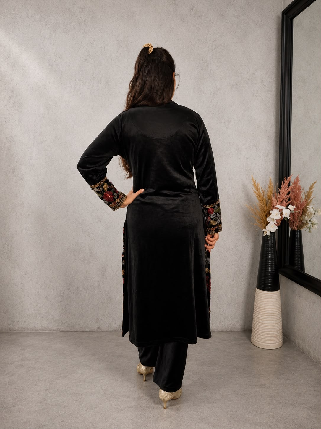Back view of black velvet Kashmiri embroidered kurta set with matching pants from Adishee