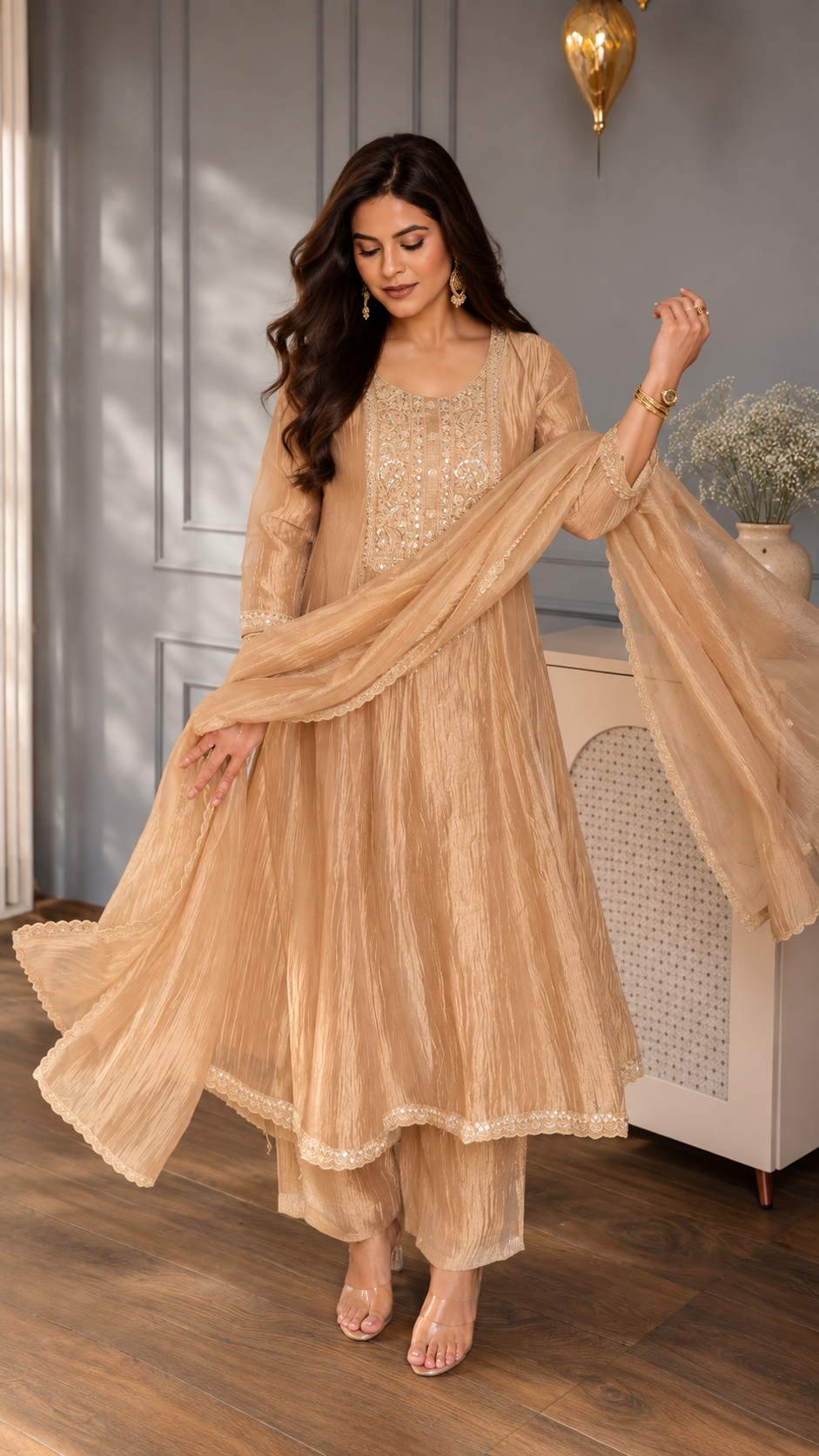 Rose gold tissue Anarkali suit with embroidered neckline, matching pants and dupatta.