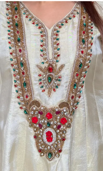 Premium ivory shimmer tissue Anarkali set with red green and gold jewel work on the yoke and matching dupatta.