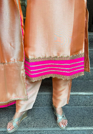 Peach Giraffe Tissue 3-piece set with hot pink and gold embroidered neckline, matching pants and dupatta.