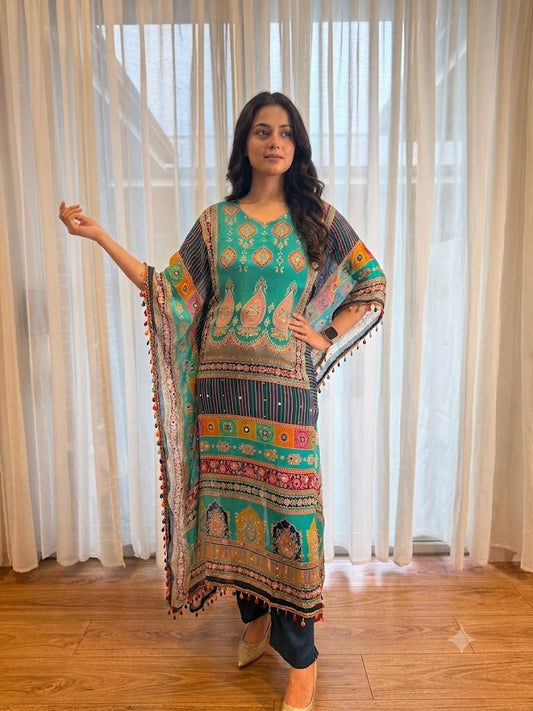 Woman wearing a turquoise printed kaftan kurta with colourful ethnic paisley patterns, tassel trim and matching navy pants, showcasing premium Indian ethnic fashion by Adishee.
