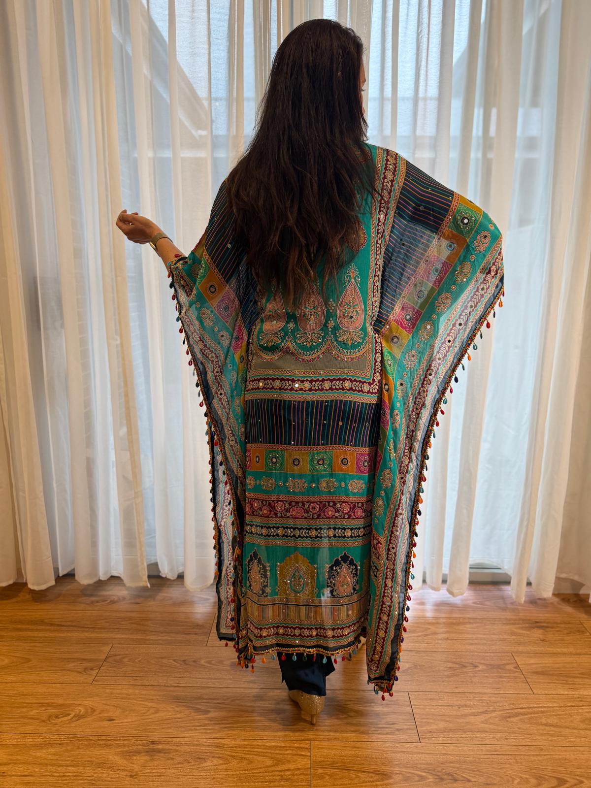 Woman wearing a turquoise printed kaftan kurta with colourful ethnic paisley patterns, tassel trim and matching navy pants, showcasing premium Indian ethnic fashion by Adishee.