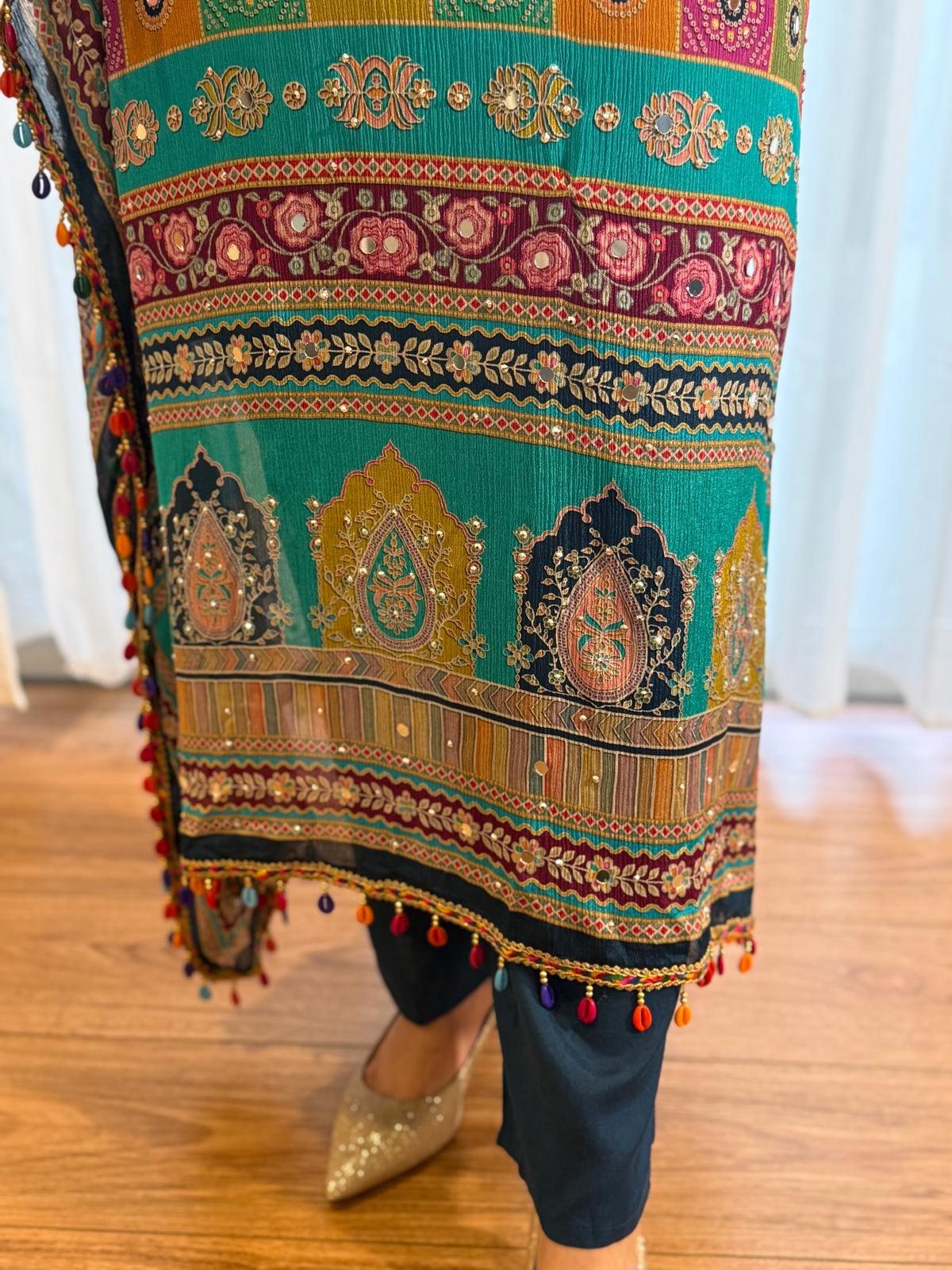 Woman wearing a turquoise printed kaftan kurta with colourful ethnic paisley patterns, tassel trim and matching navy pants, showcasing premium Indian ethnic fashion by Adishee.