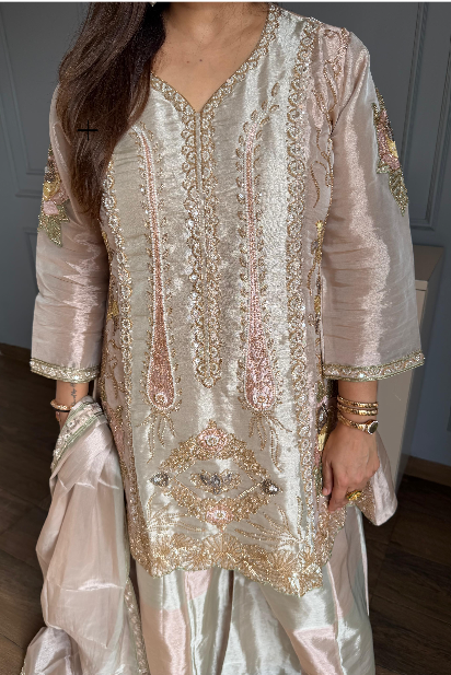 Ivory soft tissue suit with heavy embroidery, wide-leg pants and matching dupatta.