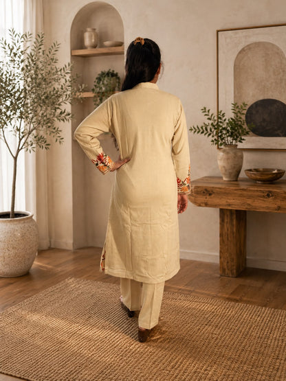 Back view of cream Kashmiri kurta set with matching pants and sleeve detailing from Adishee