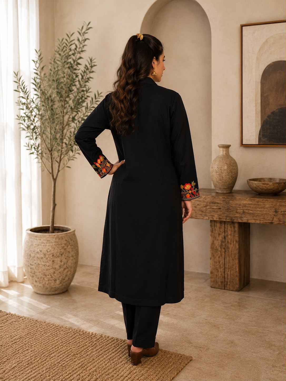 Back view of black Kashmiri kurta set with embroidered sleeve detailing and matching pants from Adishee