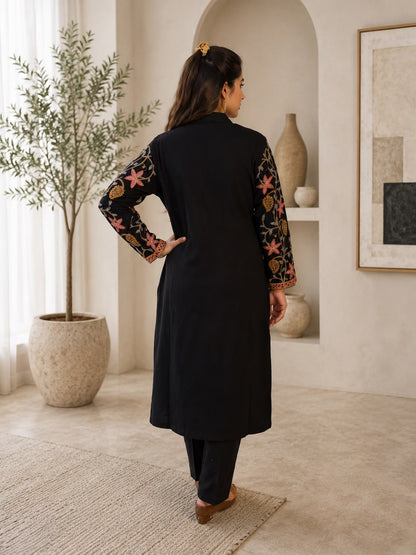 Back view of black Kashmiri kurta set with printed sleeves and matching pants from Adishee